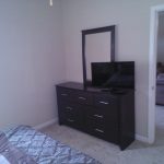 Bedroom with TV in two bedroom unit The Crossings